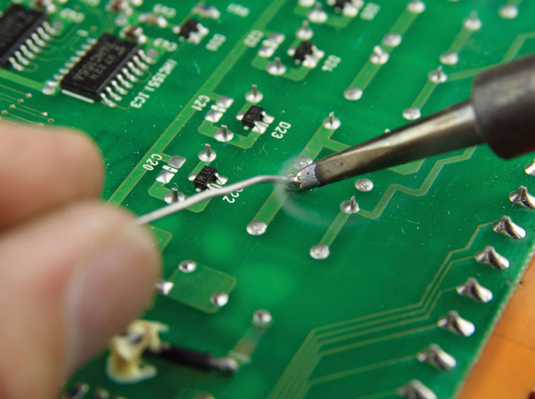 Close up of soldering a printed circuit board
