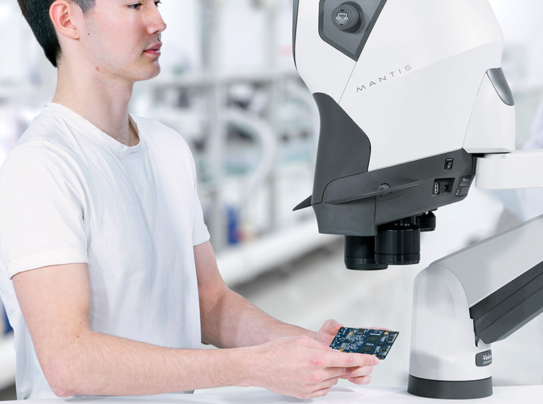 Man viewing pcb under Mantis 768x572px copy Mantis Elite Cam microscope used by man for cable connector inspection