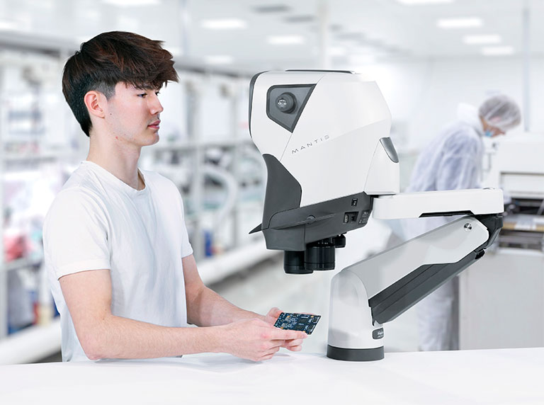 Man insepecting pcb using Mantis on Verso stand