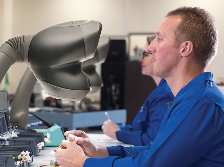 OPTA-body-image-universal-arm-people-electronic-768x572px Technician using Mantis Elite stereo microscope for dental application