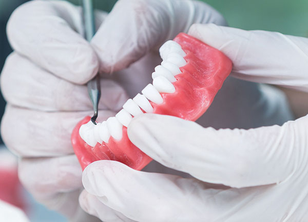 dental_shutterstock_490406908-cropped-600×433 Teeth moulding being worked with a dental tool